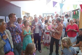 Tenth anniversary party: crowded atrium viewed at ground floor level.