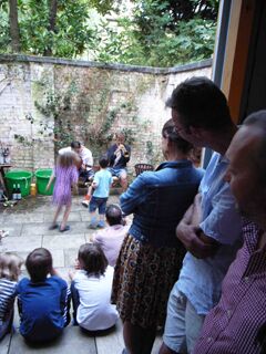 Tenth anniversary party: view from unit 3 into rear courtyard of Theo playing guitar, Gabriel playing trumpet, Freda and Luca dancing.